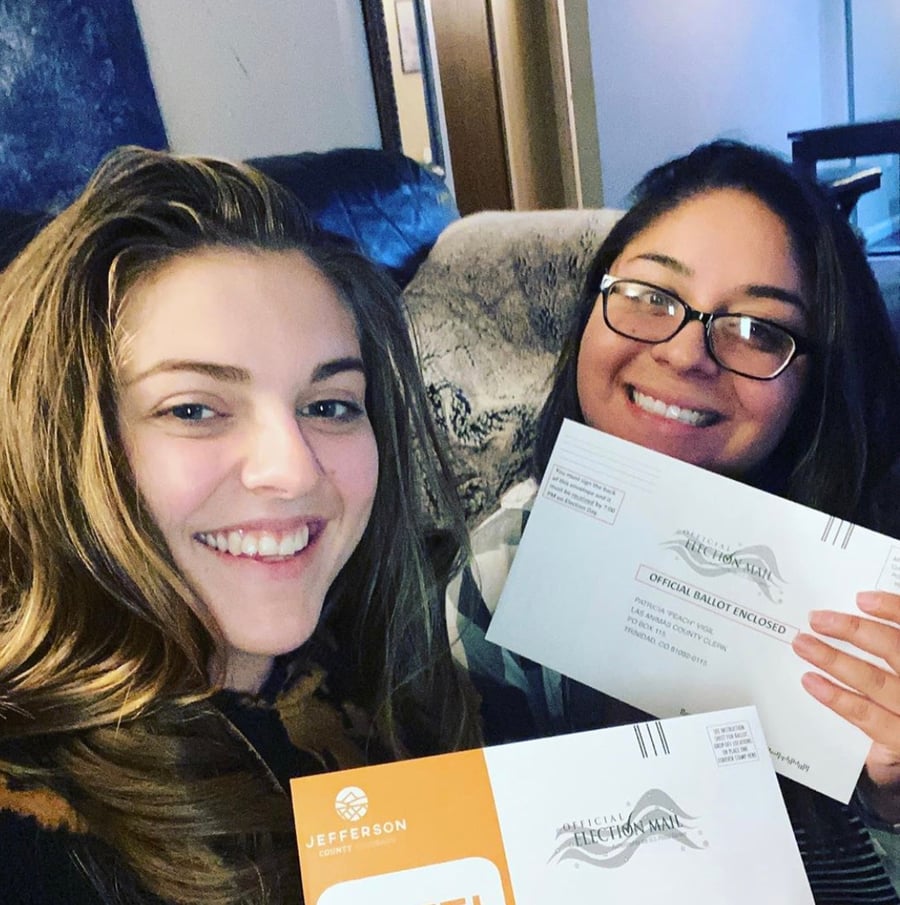 Young women hold their ballots